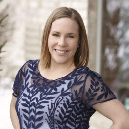 Female dental team member smiling in a professional staff portrait