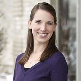 Female dental staff member smiling in a professional headshot portrait
