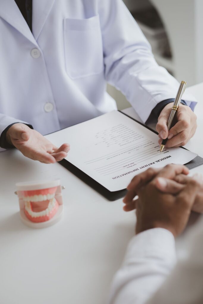 Dentist reviewing paperwork with a patient during a dental office visit